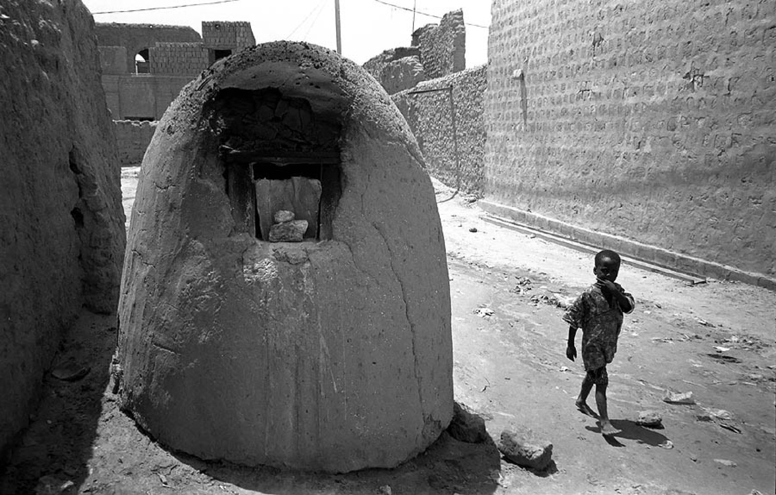 A street in Timbuktu with one of its mud bread ovens, photographed in 2000; the journey's starting point.