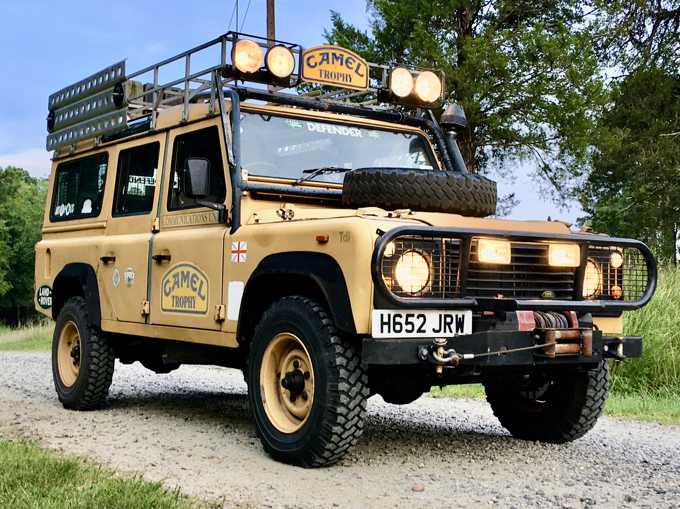 Camel Trophy 110 — Tdi-era Defender 110 in Camel Trophy livery with roof rack, lamps and winch