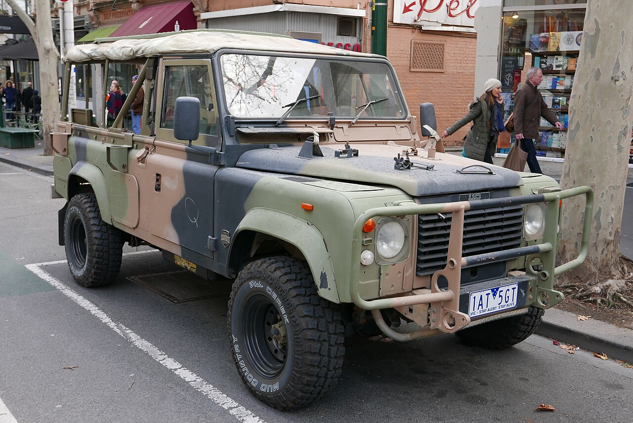 FFR — Preserved 1990 ex-Australian Army Perentie 110 in Auscam, Melbourne 2015. The paired antenna-base shrouds on the tray sides and the battery access door low on the tub identify it as a Fitted For Radio vehicle, although the photographer's title calls it a '110 County'.