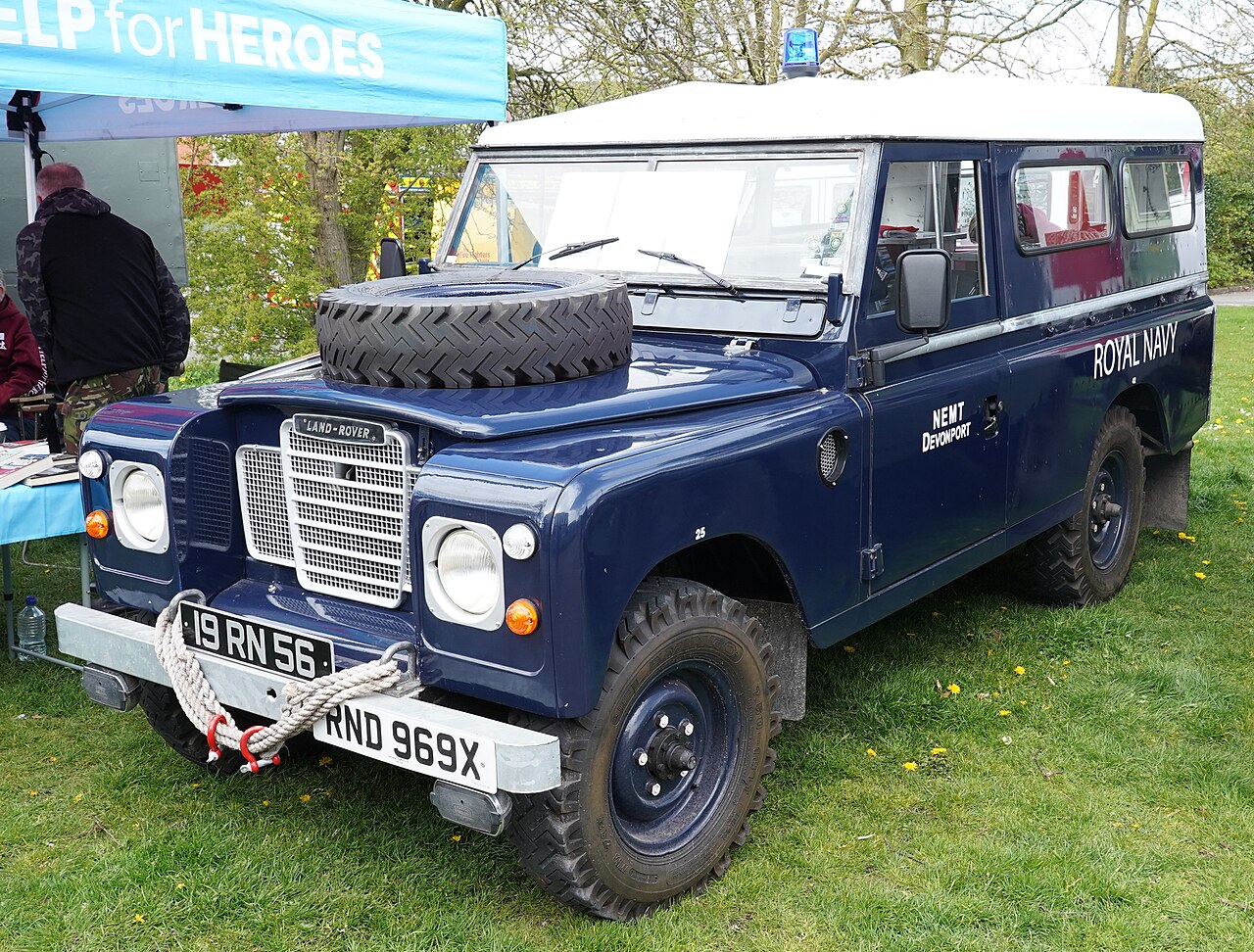 Royal Navy Rescue — Preserved long-wheelbase Royal Navy Land Rover 19 RN 56 (NEMT Devonport) in the same gloss dark navy scheme with white roof, bonnet spare and rope-dressed bumper