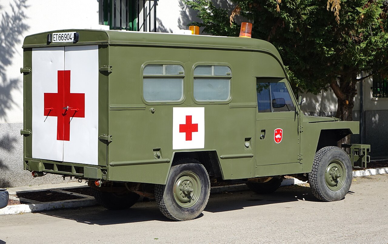 Santana Ambulance — Spanish Army Land Rover Santana 109 ambulance, registration ET 66904 — olive green box body with red cross panels, twin rear doors and amber roof beacons