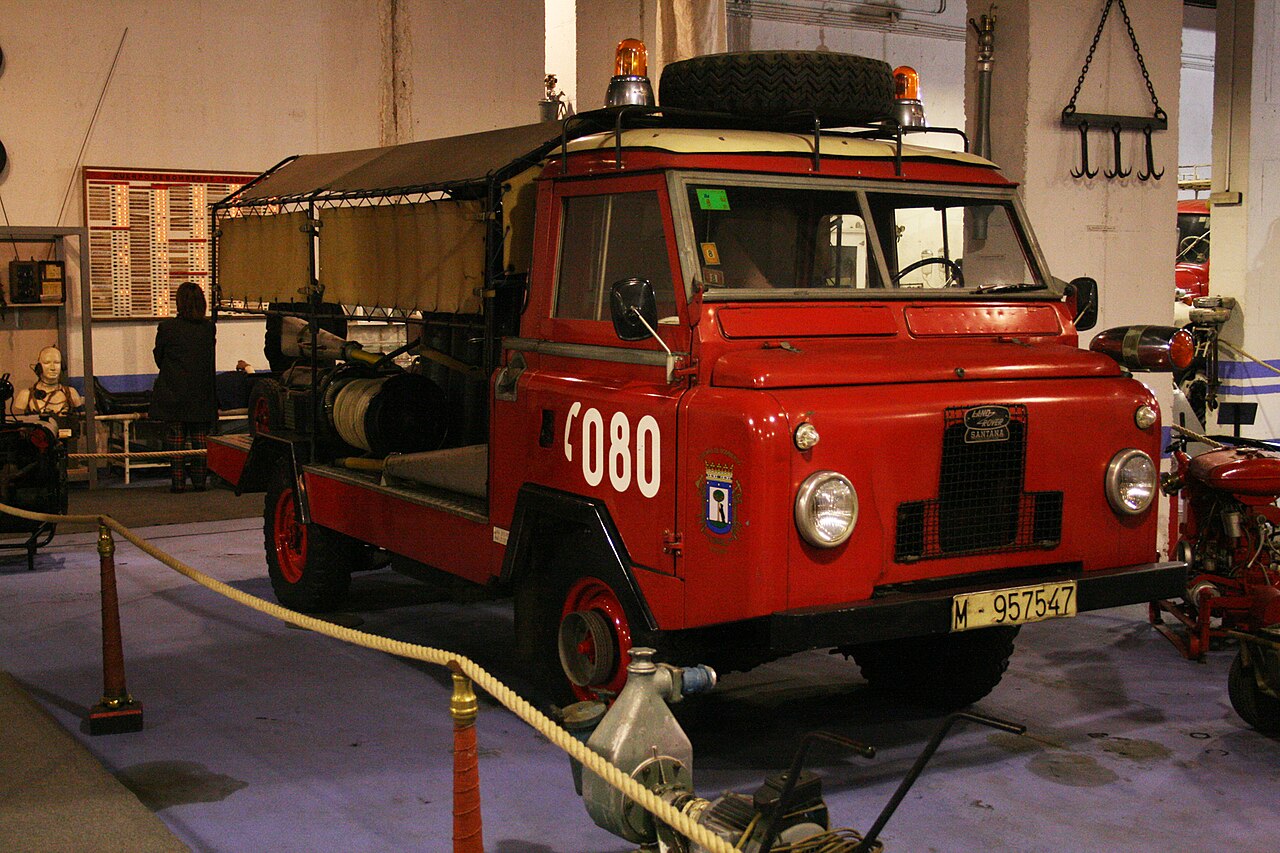 1300 Bomberos — Preserved Madrid fire brigade Santana 1300 (M-957547), retired from service — red livery with the city arms and '080' on the cab, twin roof beacons and a canvas-tilt rear body carrying hose reels